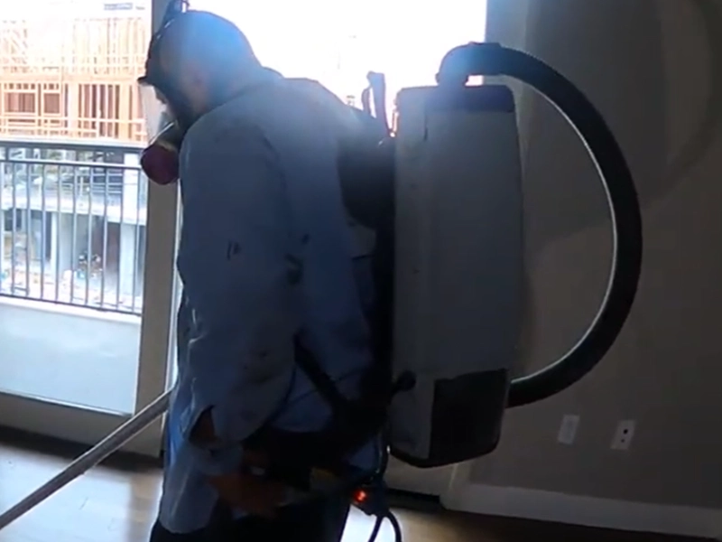 Technician wearing a backpack HEPA vacuum during mold cleanup